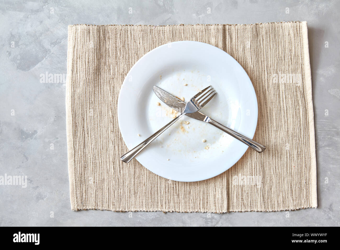 Metal fork and knife on a stone table. arrangement of cutlery after