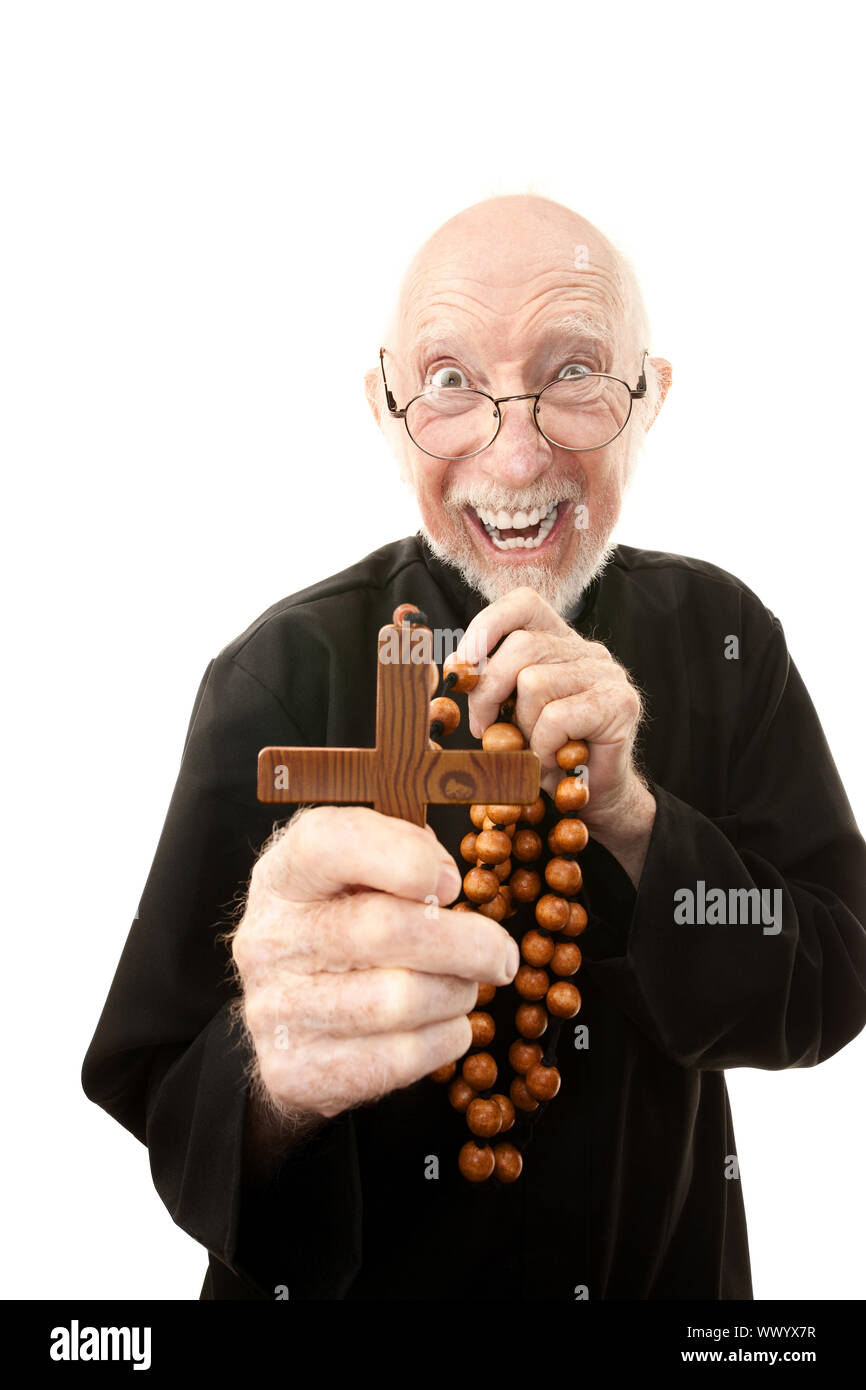 Priest warding off evil with wooden cross Stock Photo