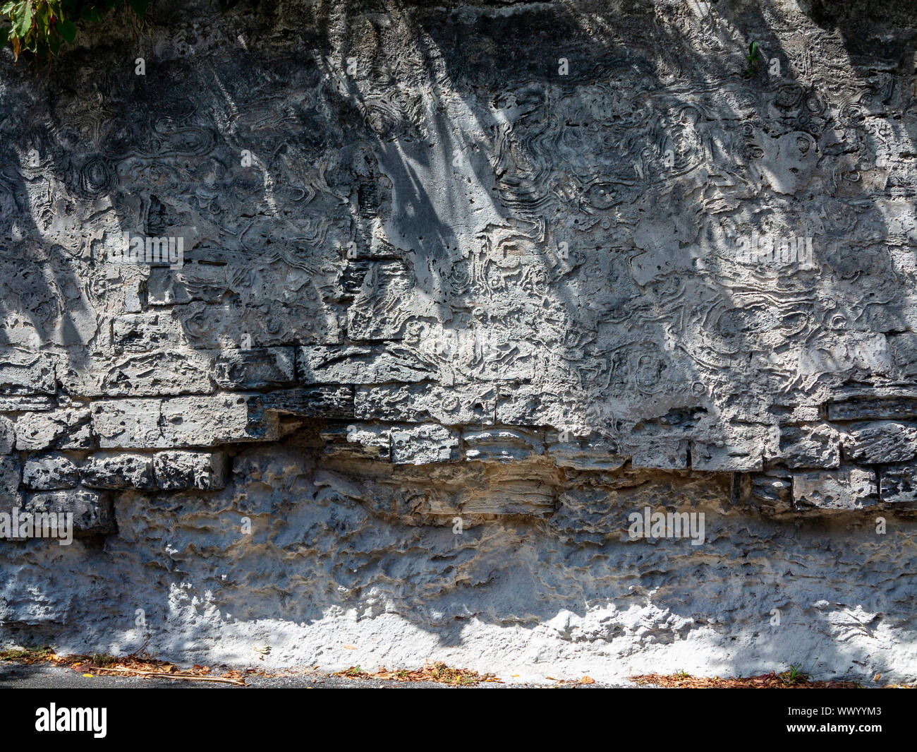 Wall constructed of local volcanic rock in Bermuda Stock Photo