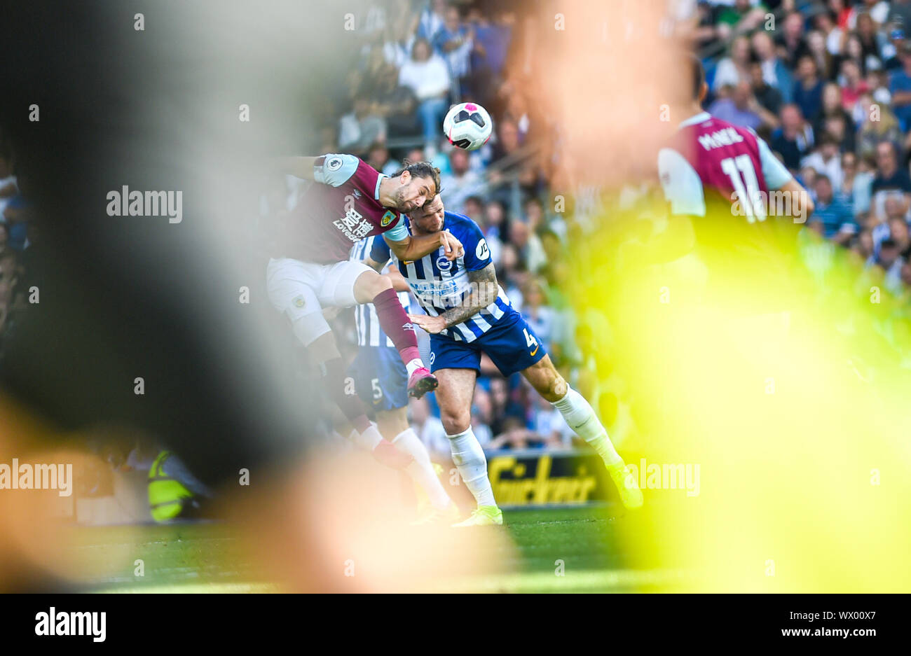 Jay Rodriguez of Burnley challenges Shane Duffy of Brighton as they are framed by the referee assistants flag during the Premier League match between Brighton and Hove Albion and Burnley at the American Express Community Stadium , Brighton , 14 September 2019 - Editorial use only. No merchandising. For Football images FA and Premier League restrictions apply inc. no internet/mobile usage without FAPL license - for details contact Football Dataco Stock Photo