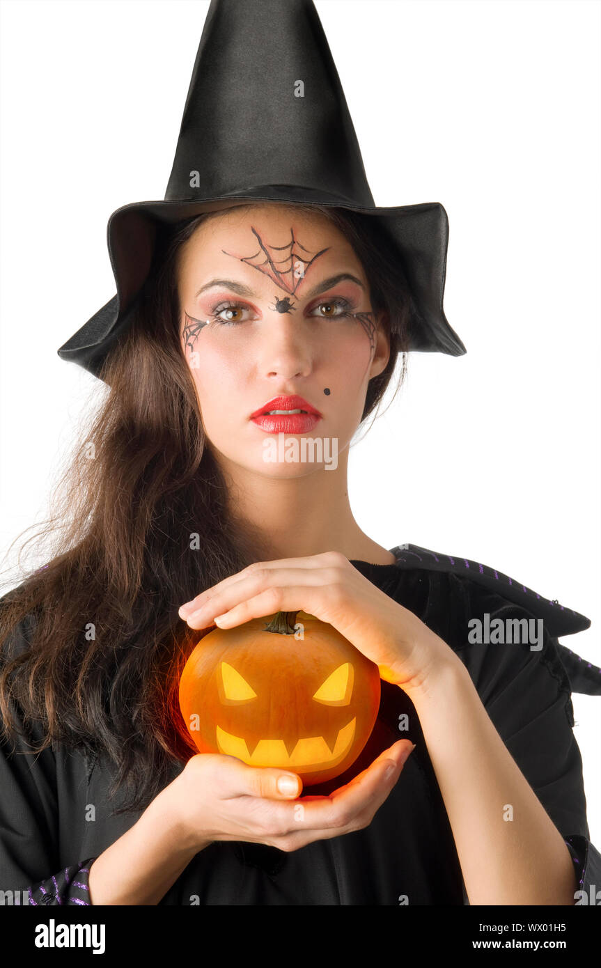 cute girl with witch hat and a little pumpkin betweeen hands Stock ...