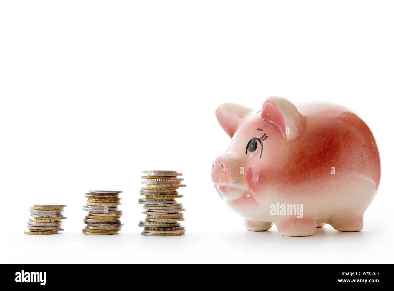 Pink piggy bank isolated on white background with coins Stock Photo - Alamy