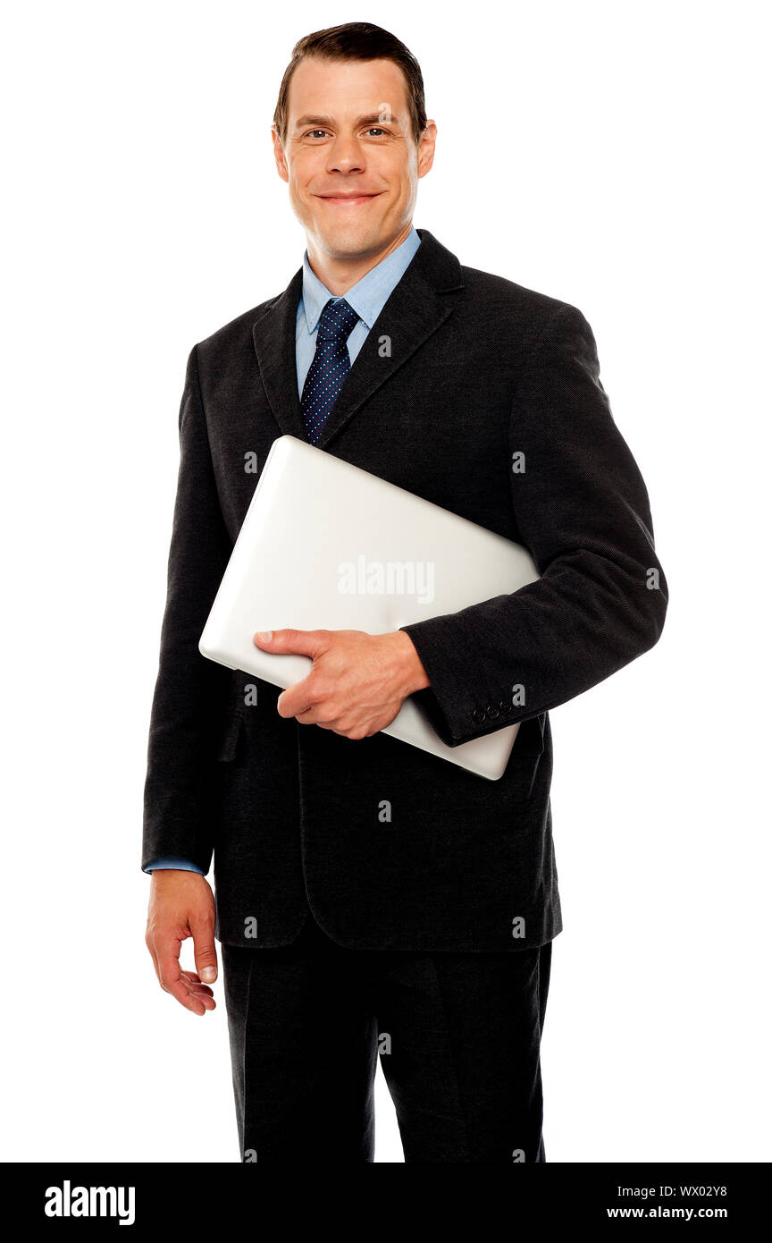 Handsome business executive holding laptop isolated against white ...