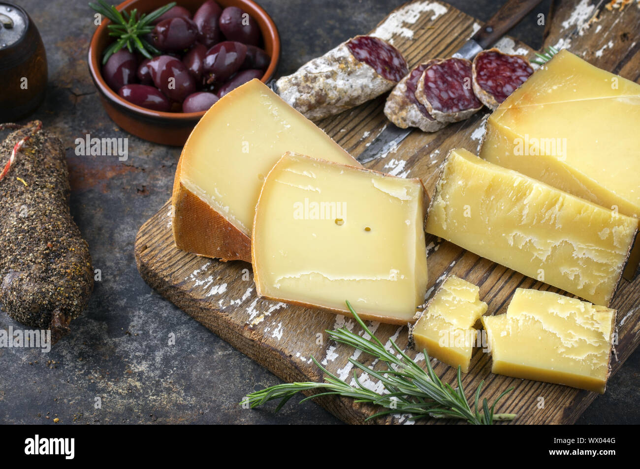Traditional French cold cuts with Cheese and Salami as top view on old cutting board Stock Photo
