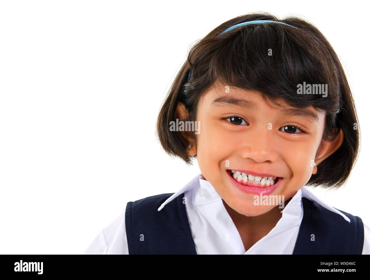 Head shot portrait of Southeast Asian primary school student over white background Stock Photo