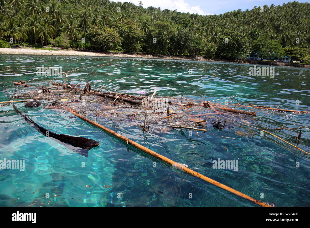 Flotsam collects in a bay off the coast of Panaon Island Stock Photo
