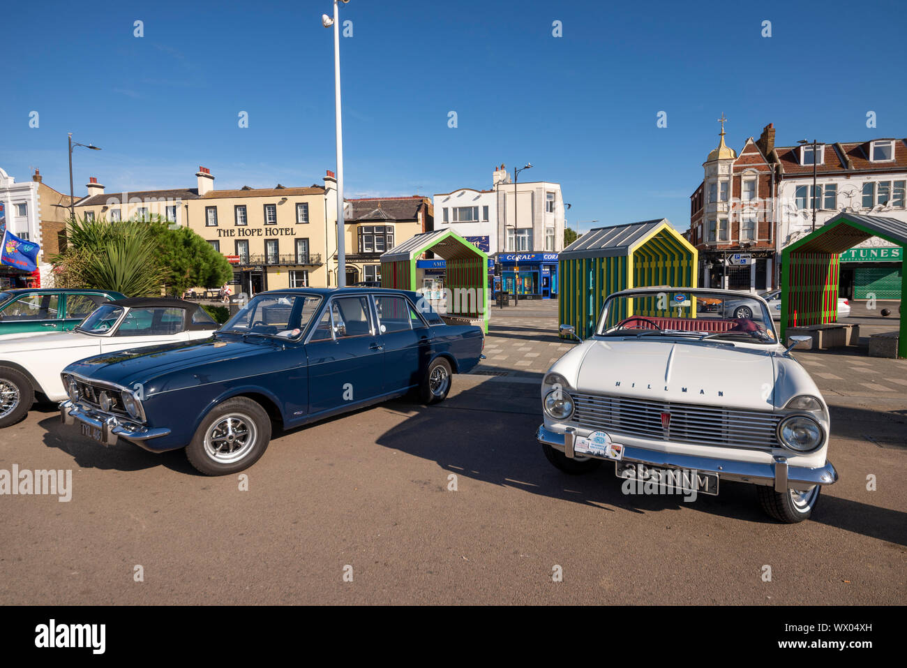 Cars on the Beach car show on Marine Parade, Southend on Sea, Essex, UK. Ford Cortina and Hillman Minx classic cars with coloured shelters Stock Photo