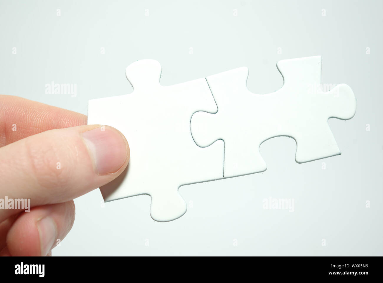 puzzle in hand isolated on white background Stock Photo - Alamy