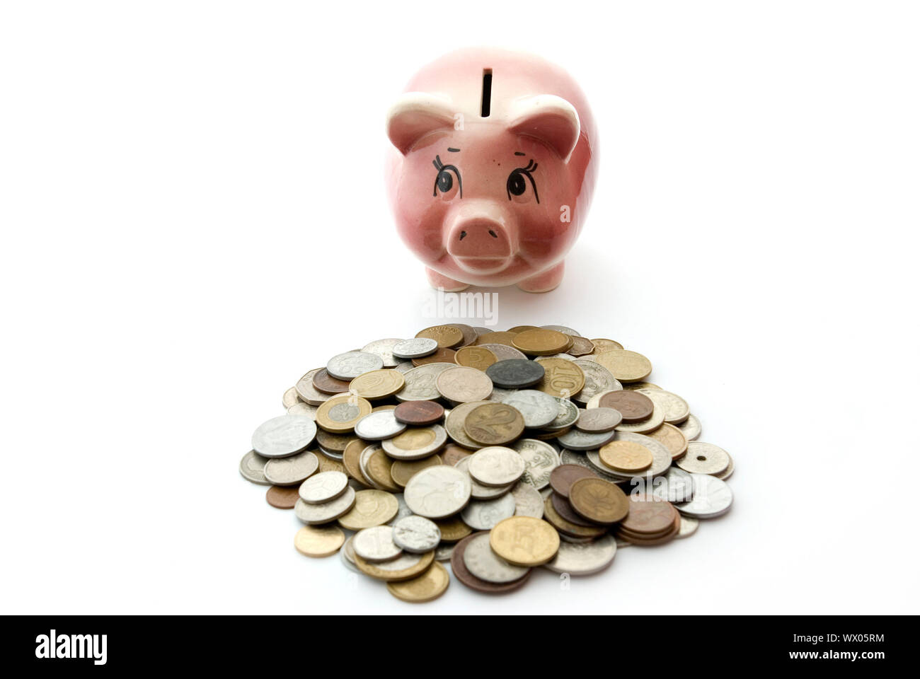 Pink piggy bank isolated on white background with coins Stock Photo - Alamy