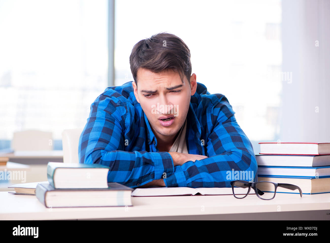 Student studying in the empty library with book preparing for ex Stock Photo