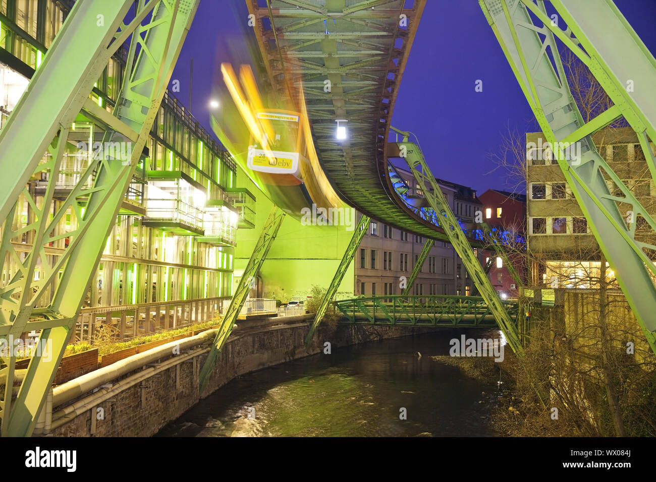 uspension railway in motion over the river Wupper at night, Wuppertal, Germany, Europe Stock Photo