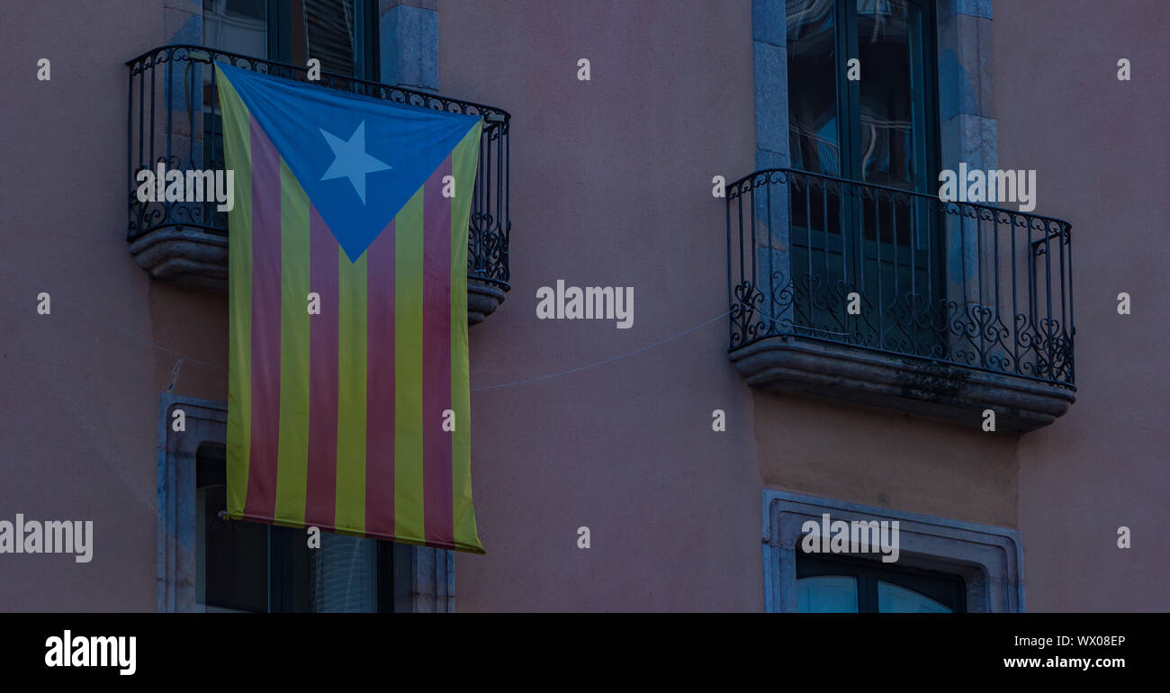 A picture of the Catalunya flag hanging off a balcony in Girona. Stock Photo