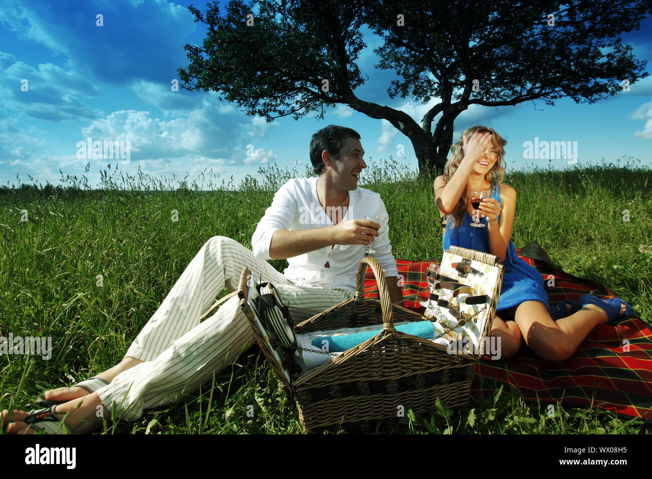 man and woman on picnic in green grass Stock Photo - Alamy