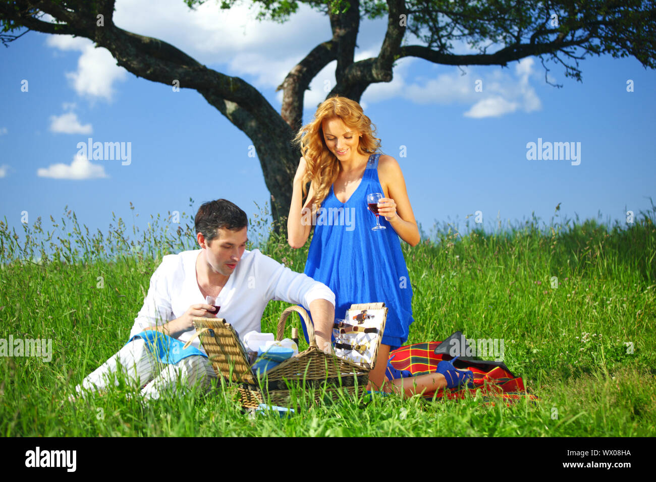 man and woman on picnic in green grass Stock Photo - Alamy