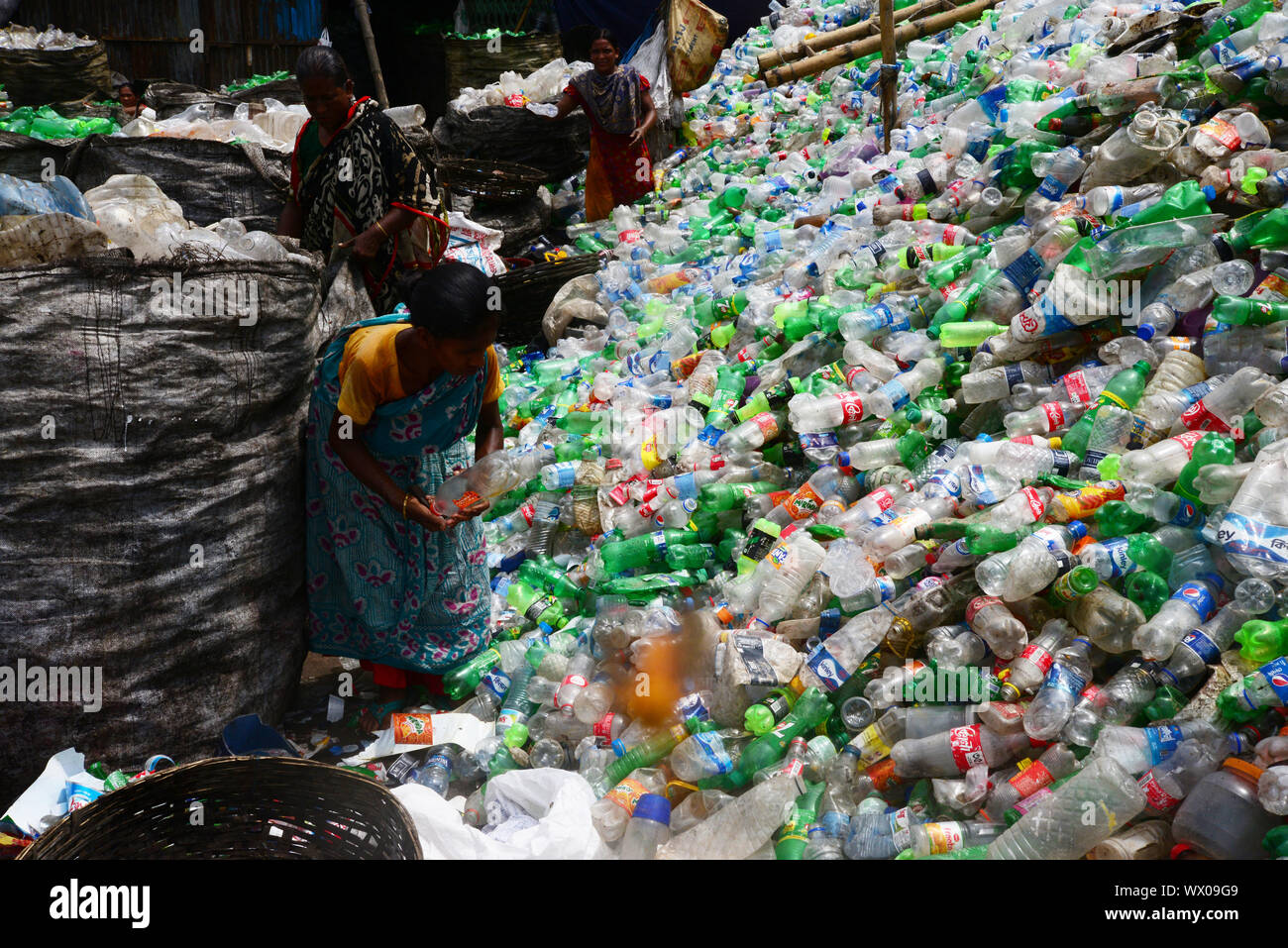 Bangladeshi women labor works in a plastic recycling factory in Dhaka, Bangladesh, on September