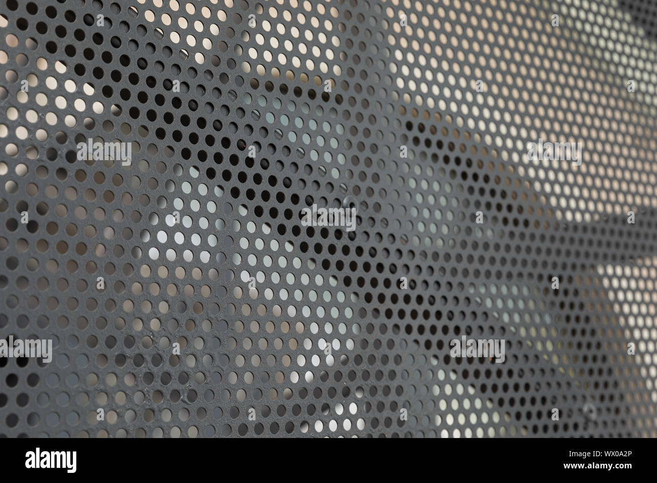 Diagonal view of gray perforated metal panel at building facade Stock ...