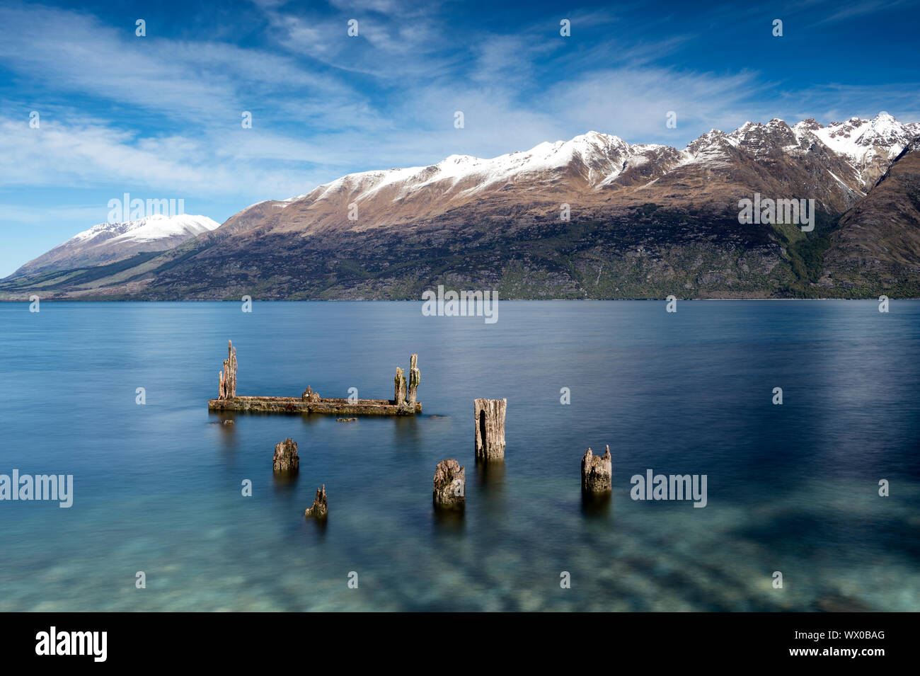 Decayed jetty, old wooden posts in Lake Wakatipu at Glenorchy, Otago Region, South Island, New Zealand, Pacific Stock Photo
