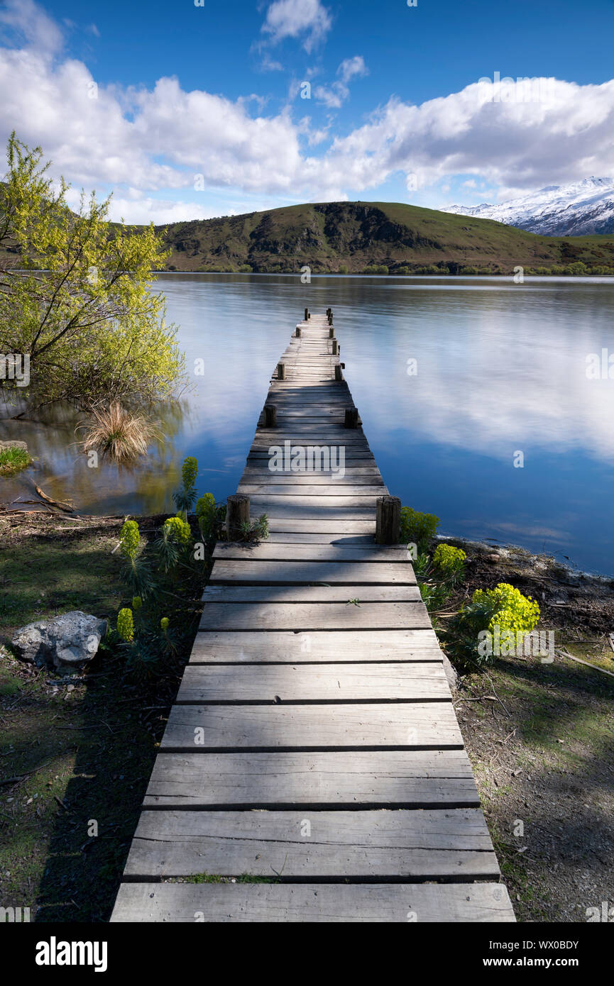 Old wooden jetty at Lake Hayes, Wakatipu Basin in Central Otago, South Island, New Zealand, Pacific Stock Photo