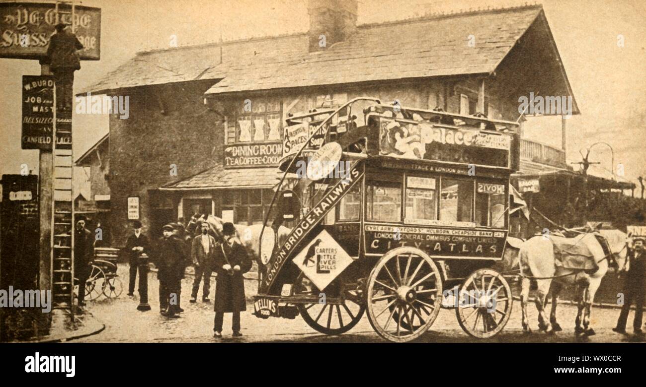 'The &quot;Express&quot; Bus', 1900, (1933). Open-top horse-drawn bus outside Ye Olde Swiss Cottage public house in north London. These express buses 'ran from Swiss Cottage via Oxford Street and Holborn to the Bank, and charged sixpence [2&#xbd; new pence] for any distance'. The back of the bus bears an advertisement for 'Carter's Little Liver Pills'. On the left a man up a ladder is painting the pub sign. From &quot;The Pageant of the Century&quot;. [Odhams Press Ltd, 1933] Stock Photo