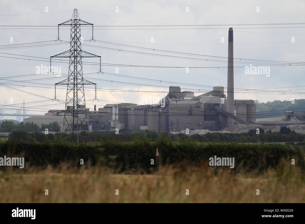 Telephoto shot of cement works at South Ferriby behind power lines. Shot taken from plot at Winterton. Stock Photo