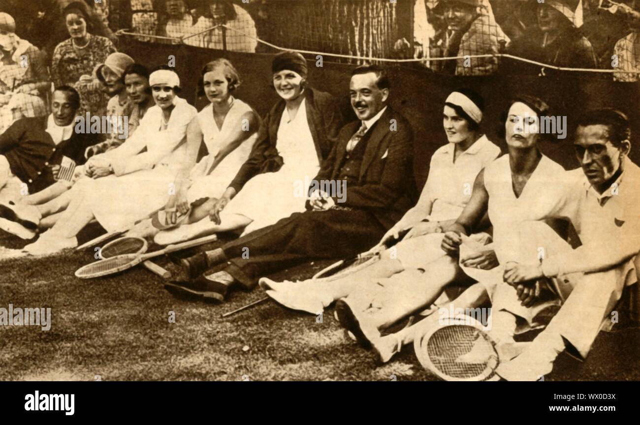 Former king Manuel II of Portugal with tennis players, Britain, 1930, (1933). 'Lady Wavertree arranged her tenth charity tennis party in this year: Cochet, Joan Lycett, Susan Palfrey, ex-King Manuel, Betty Nuthall, Eileen Bennett Fearnley Whittingstall, Ermyntrude Harvey, Elizabeth Ryan, Peggy Wood, and Prenn'. Manuel II (1889-1932) was the last king of Portugal. In October 1910 the Portuguese monarchy was overthrown by a republican revolution and Manuel was forced into exile in Britain. From &quot;The Pageant of the Century&quot;. [Odhams Press Ltd, 1933] Stock Photo