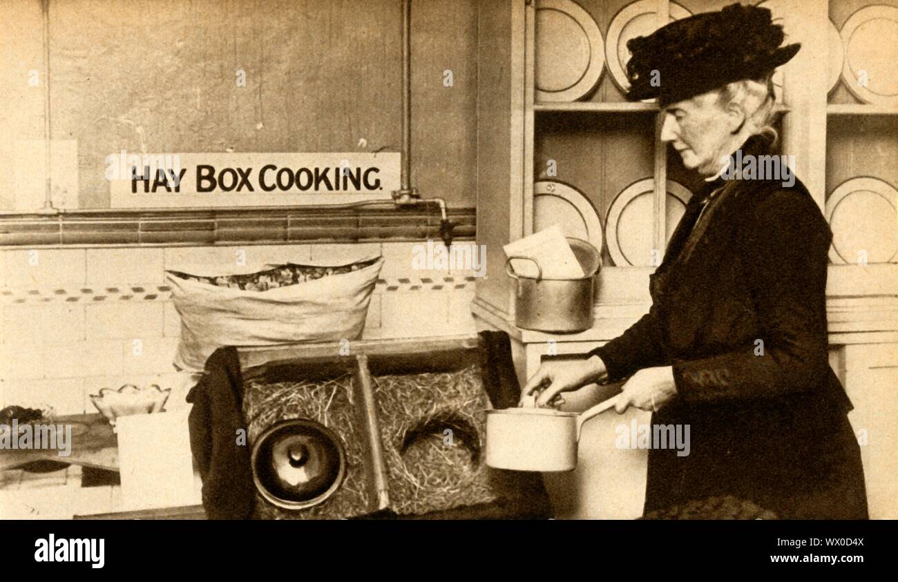 Hay box cooking, First World War, 1914-1918, (1933). 'Economy in fuel led to the adoption of hay-boxes for completing the cooking of partially cooked foods'. From &quot;The Pageant of the Century&quot;. [Odhams Press Ltd, 1933] Stock Photo