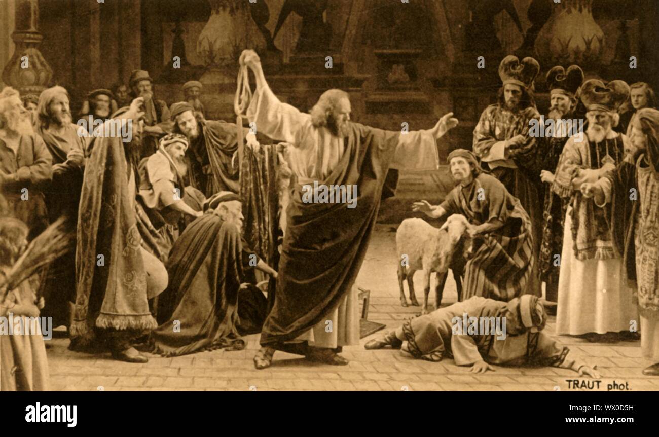 Expulsion of the moneylenders, 1922. Jesus expelling the merchants and the money-changers from the Temple: players in the Oberammergau Passion Play. The play is performed every 10 years, on open-air stages, by the inhabitants of the village of Oberammergau in Bavaria, Germany. First staged in 1634, the play tells the story of Jesus' passion, culminating in his crucifixion. The event has become a tourist attraction, with audiences coming from all over the world. Official postcard of the 1922 Oberammergau Passion Play. [F. Bruckmann, Munich, Germany, 1922] Stock Photo