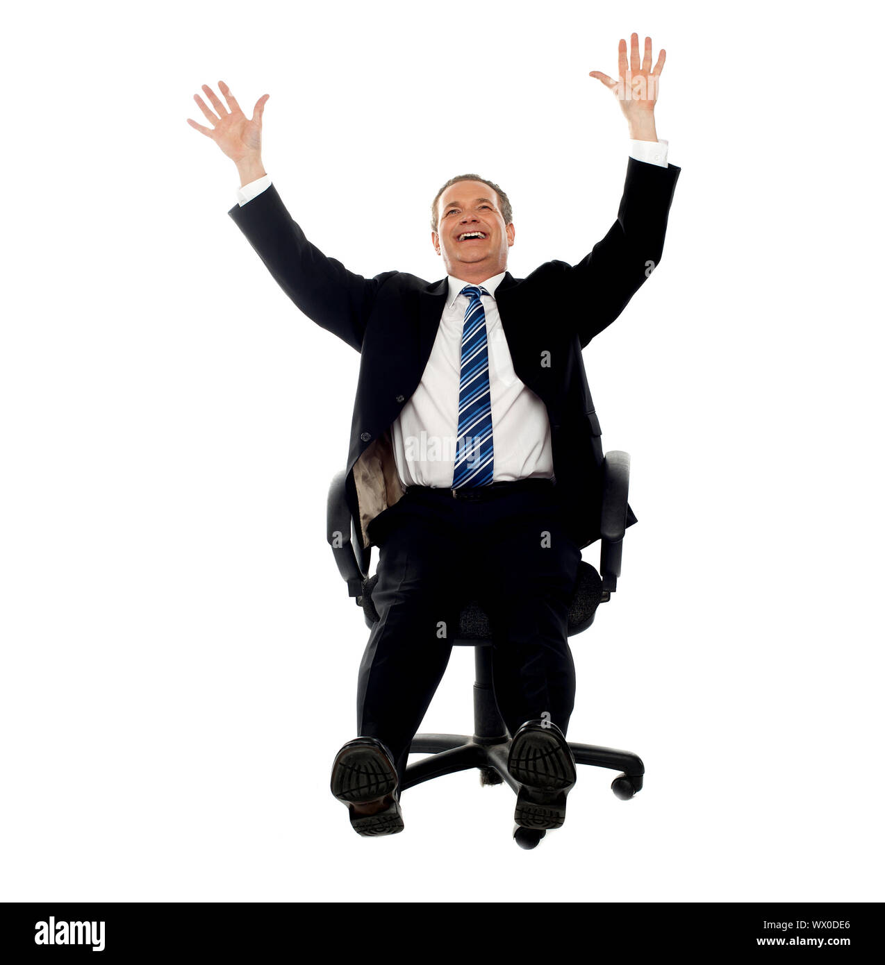 Excited businessman celebrating his success. Arms raised in air Stock ...
