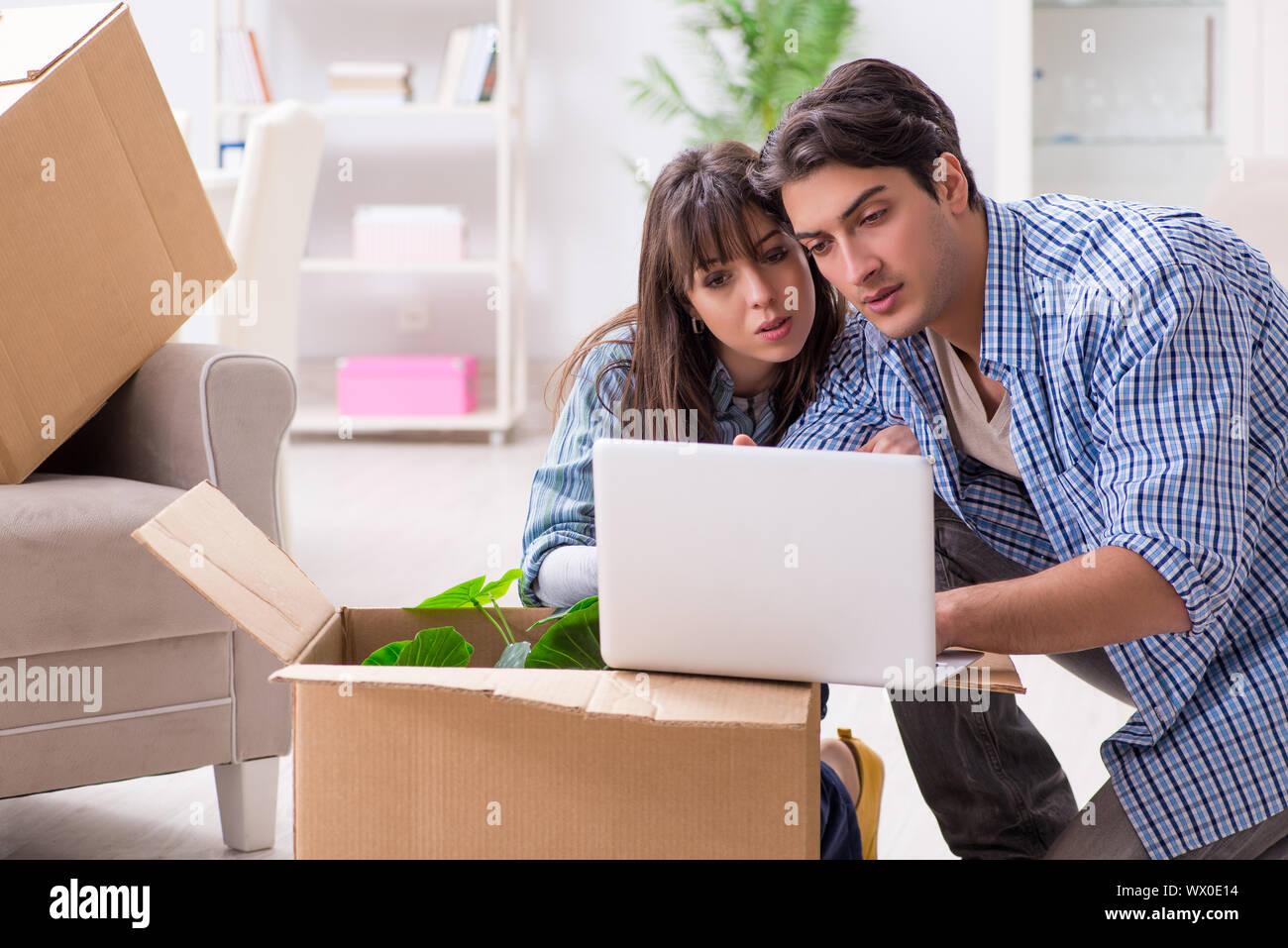Young family moving in to new apartment after paying off mortgage Stock Photo