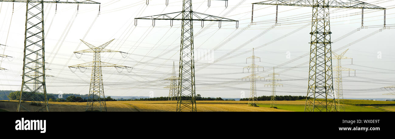 Many power pylons of a high-voltage line Stock Photo