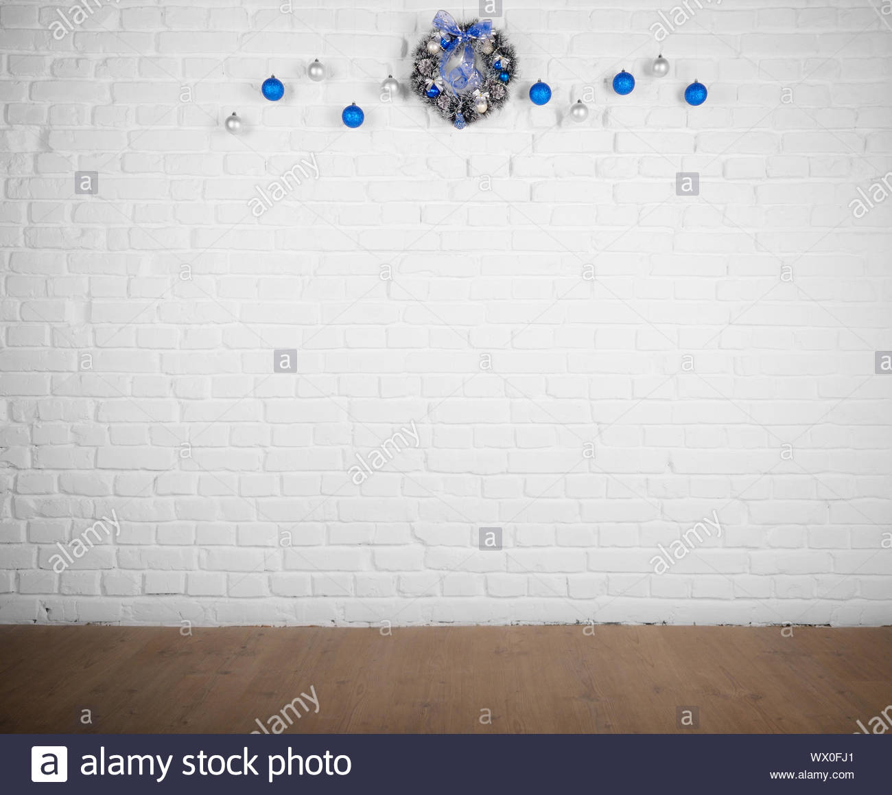 Christmas Decorations Balls And Wreath On White Brick Wall Holiday