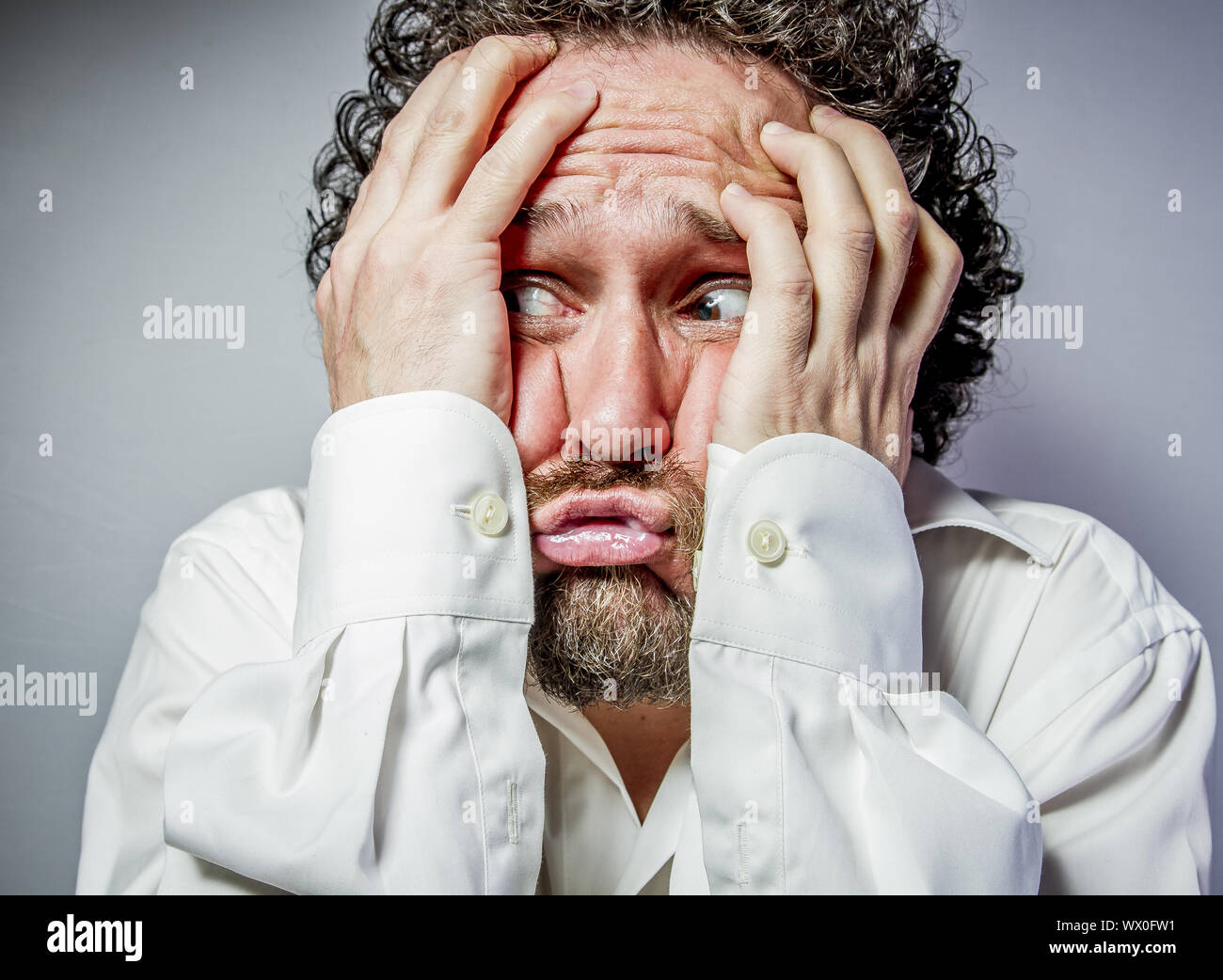 imagination and madness, man with intense expression, white shirt Stock Photo