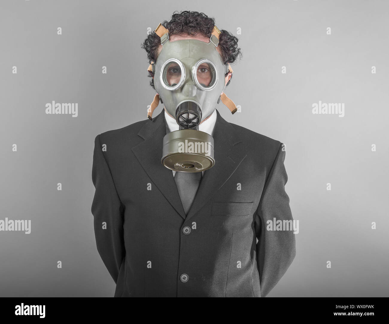 Businessman with mask, concept business dangerous for the environment or for society Stock Photo