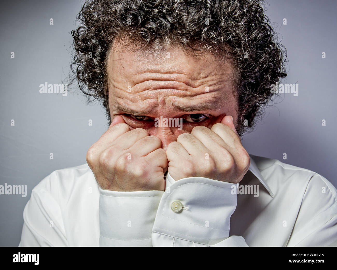 Fear, man with intense expression, white shirt Stock Photo