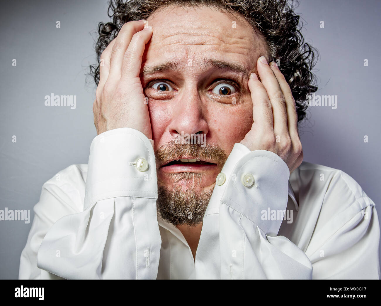 concern for the future, man with intense expression, white shirt Stock Photo