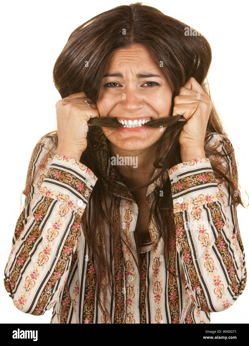 Frantic young woman biting on her long hair Stock Photo Alamy
