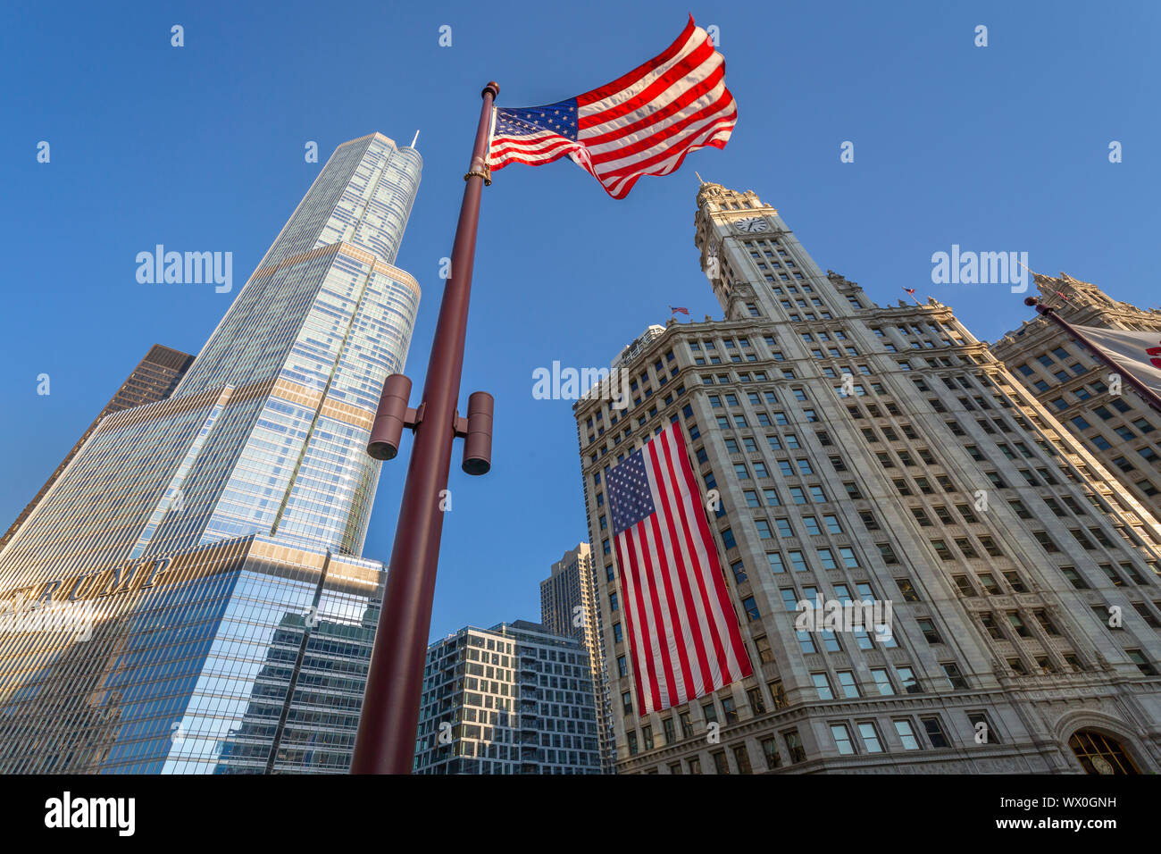 Early morning view of The Wrigley Building and Stars and Stripes US flag on DuSable Bridge, Chicago, Illinois, United States of America, North America Stock Photo