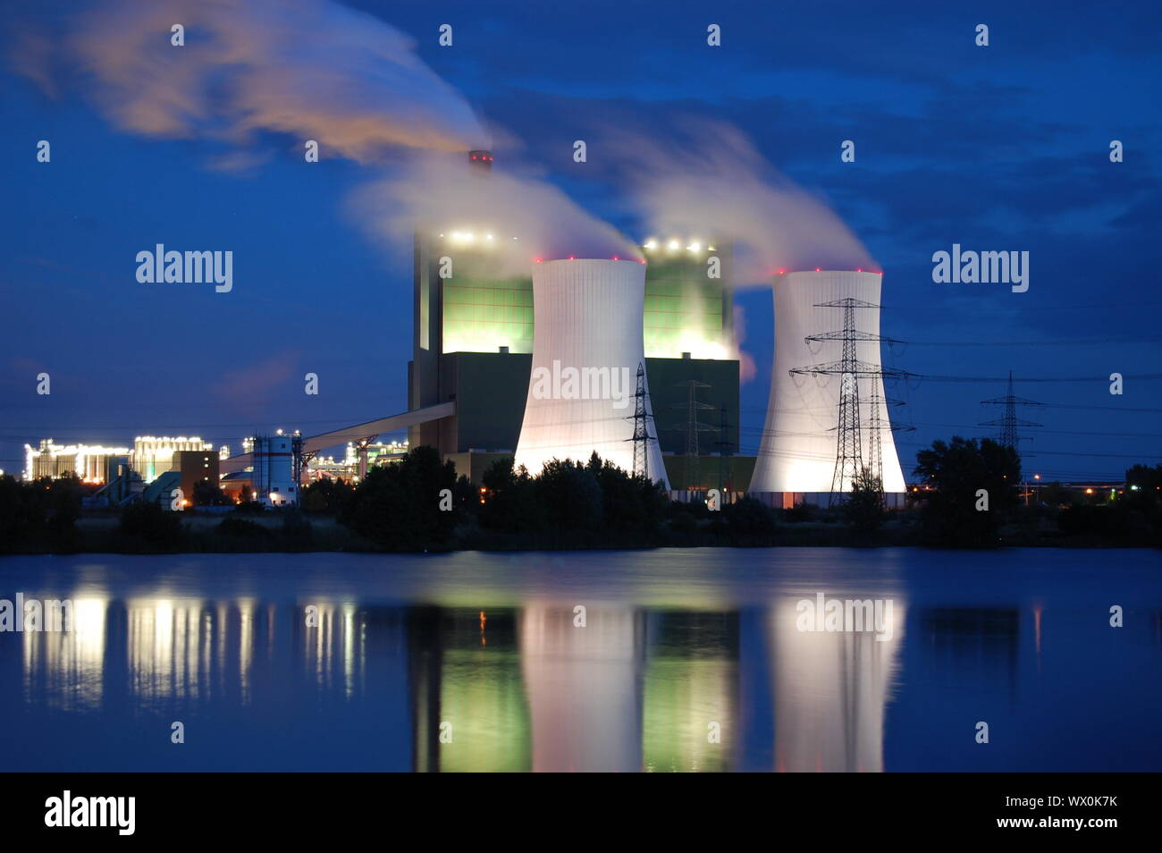 a smoking industrial power plant at night Stock Photo - Alamy