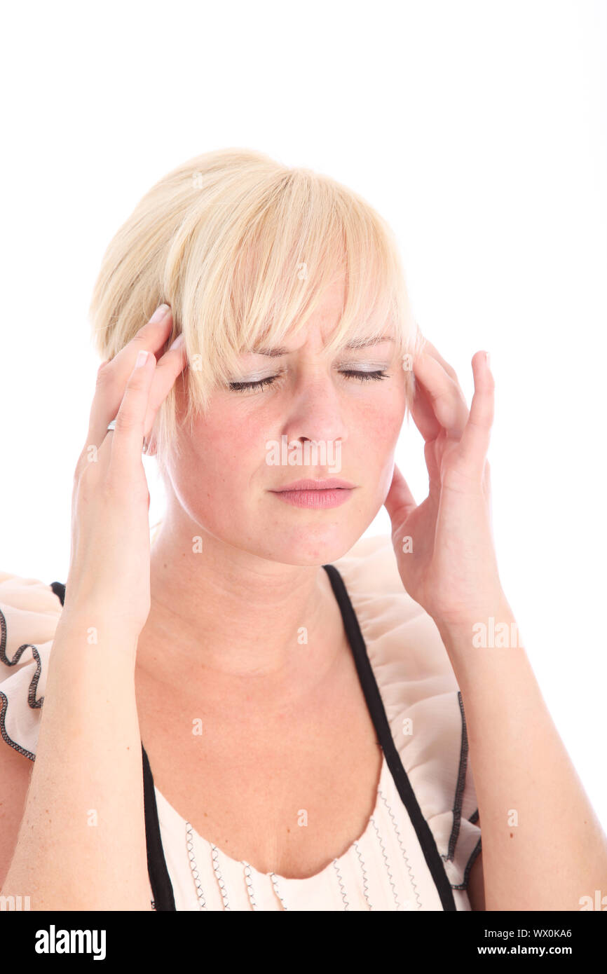 Woman suffering from a migraine headache rubbing her temples with her