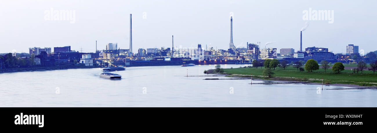 shipping on river Rhine and Chempark in Uerdingen in twilight, Krefeld, Lower Rhine, Germany, Europe Stock Photo