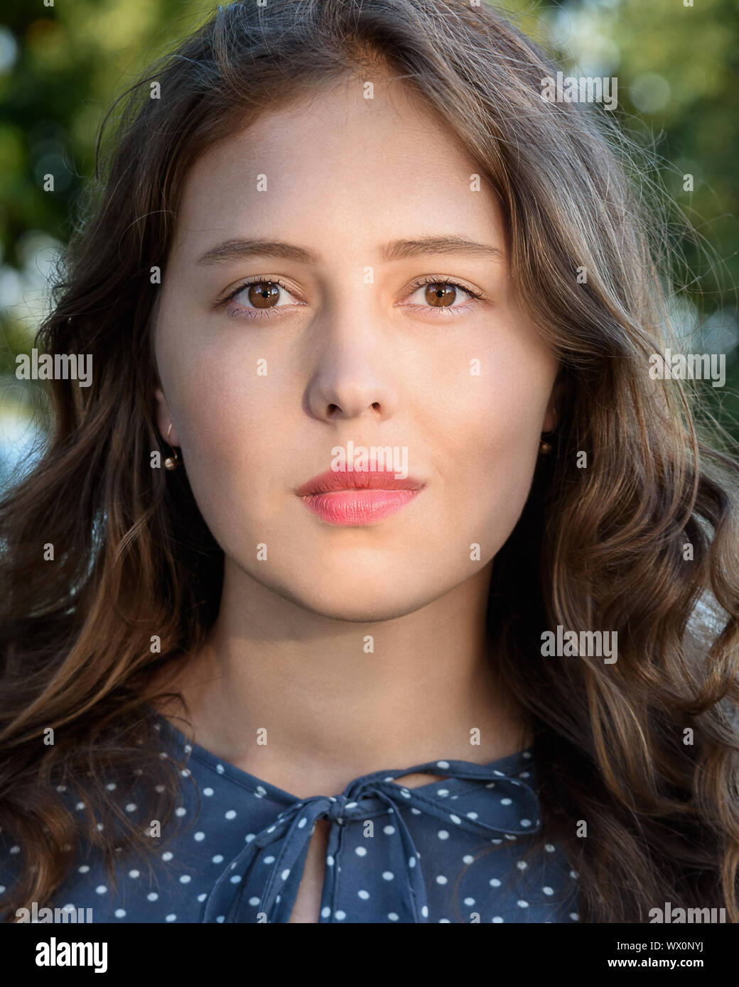 Brunette girl in the city. Portrait of girl in blue dress with long ...
