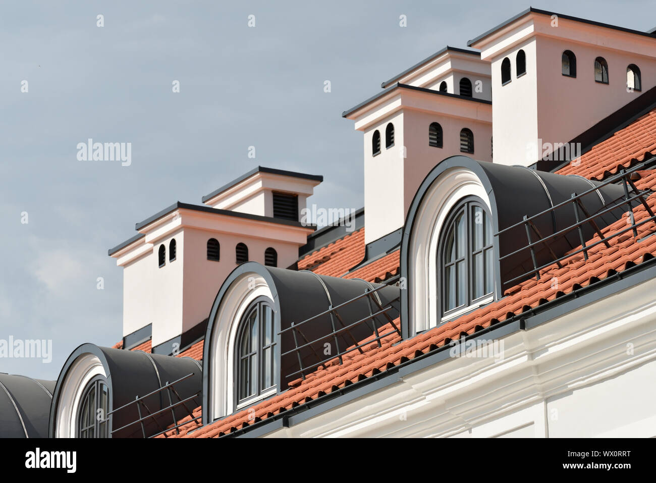 Red tile roof with a windows. Vilnius, Lithuania Stock Photo
