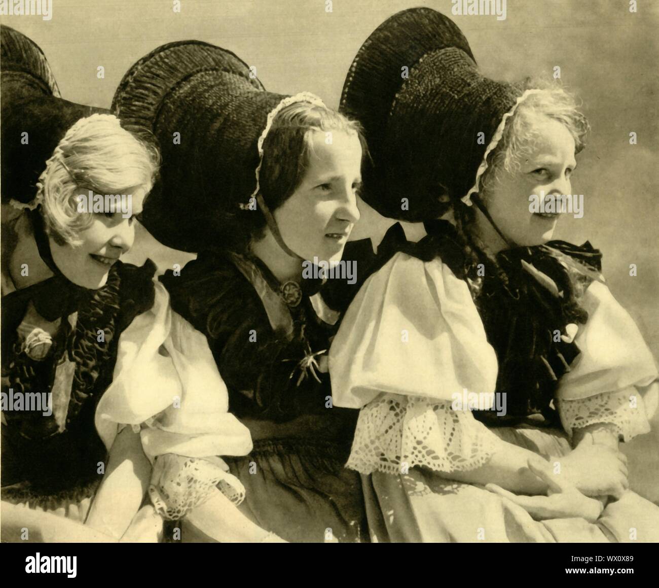 Girls in traditional costume, Vorarlberg, Austria, c1935. Austrian girls in national dress with lace blouses and elaborate bonnets, from the state of Vorarlberg which borders Germany, Switzerland and Liechtenstein. From &quot;&#xd6;sterreich - Land Und Volk&quot;, (Austria, Land and People). [R. Lechner (Wilhelm M&#xfc;ller), Vienna, c1935] Stock Photo