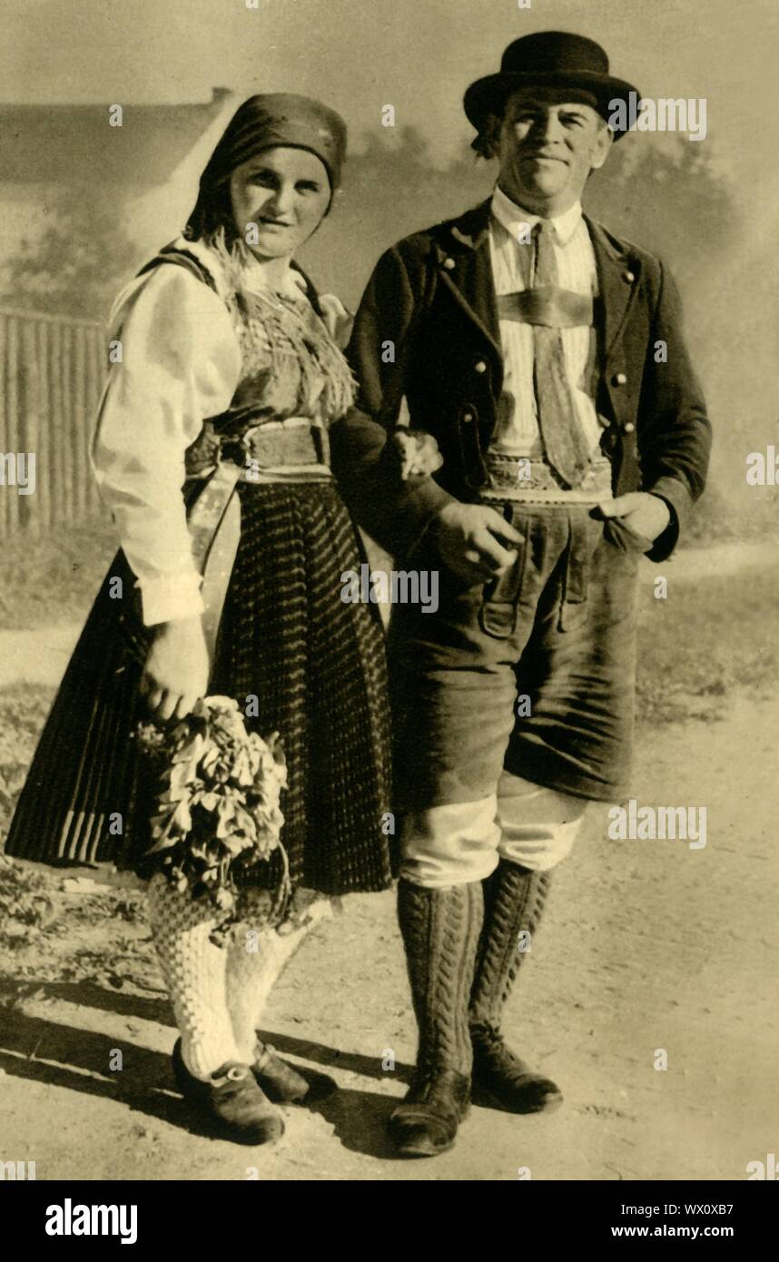 Newlyweds in traditional costume, Carinthia, Austria, c1935. Man wearing lederhosen, and woman in dirndl skirt, from the state of Carinthia. From &quot;&#xd6;sterreich - Land Und Volk&quot;, (Austria, Land and People). [R. Lechner (Wilhelm M&#xfc;ller), Vienna, c1935] Stock Photo