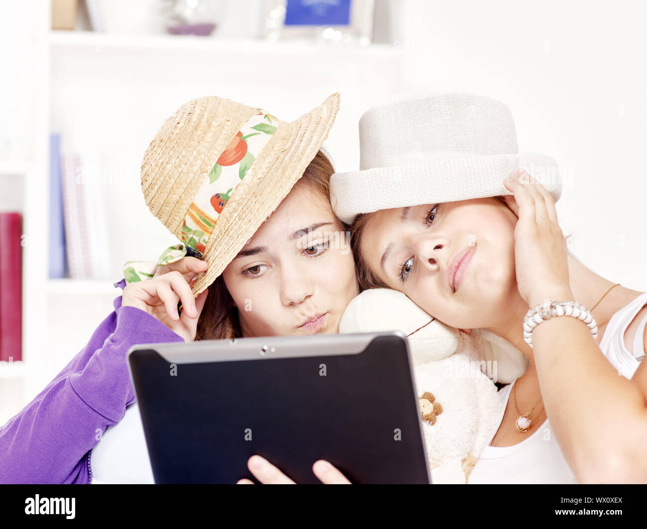 Two happy teenage girls having fun using touchpad computer Stock Photo ...