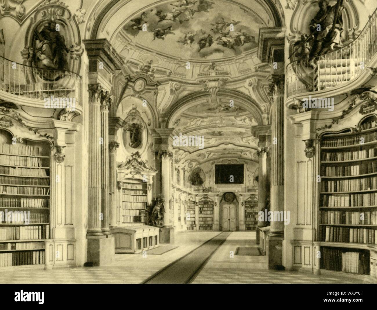 The Library, Admont Abbey, Austria, c1935. The Baroque library at Admont Abbey is the largest monastic library in the world. Designed by Joseph Hueber and built in 1776, the library is 70 metres long, 14 metres wide and 13 metres high. The cupolas are decorated with frescoes by Bartolomeo Altomonte. Admont Abbey is a Benedictine monastery in the town of Admont in the state of Styria. From &quot;&#xd6;sterreich - Land Und Volk&quot;, (Austria, Land and People). [R. Lechner (Wilhelm M&#xfc;ller), Vienna, c1935] Stock Photo