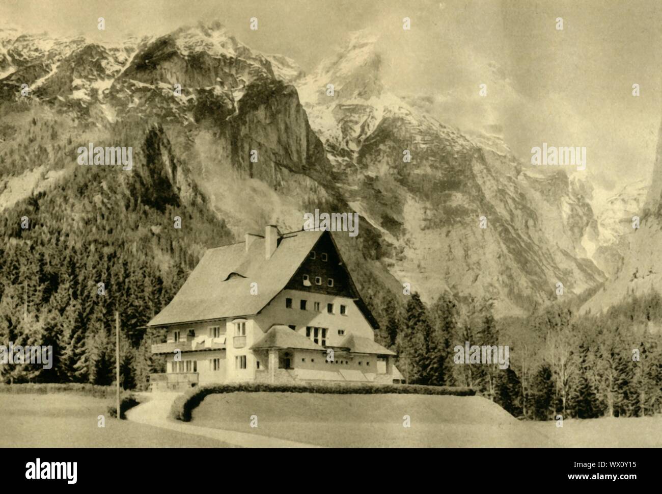 Hinterstoder, Upper Austria, c1935. House with typical steeply pitched roof in the village of Hinterstoder which is surrounded by the mountains of the Totes Gebirge range. The angle of the roof is designed to make it more difficult for snow to settle. From &quot;&#xd6;sterreich - Land Und Volk&quot;, (Austria, Land and People). [R. Lechner (Wilhelm M&#xfc;ller), Vienna, c1935] Stock Photo