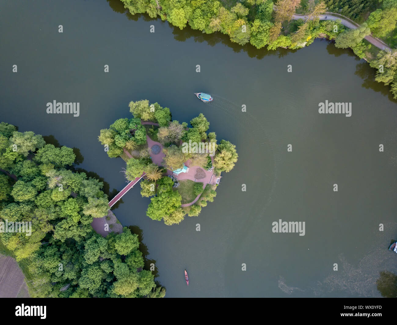 small lake in the middle of a forest and an island with a bridge, top view Stock Photo