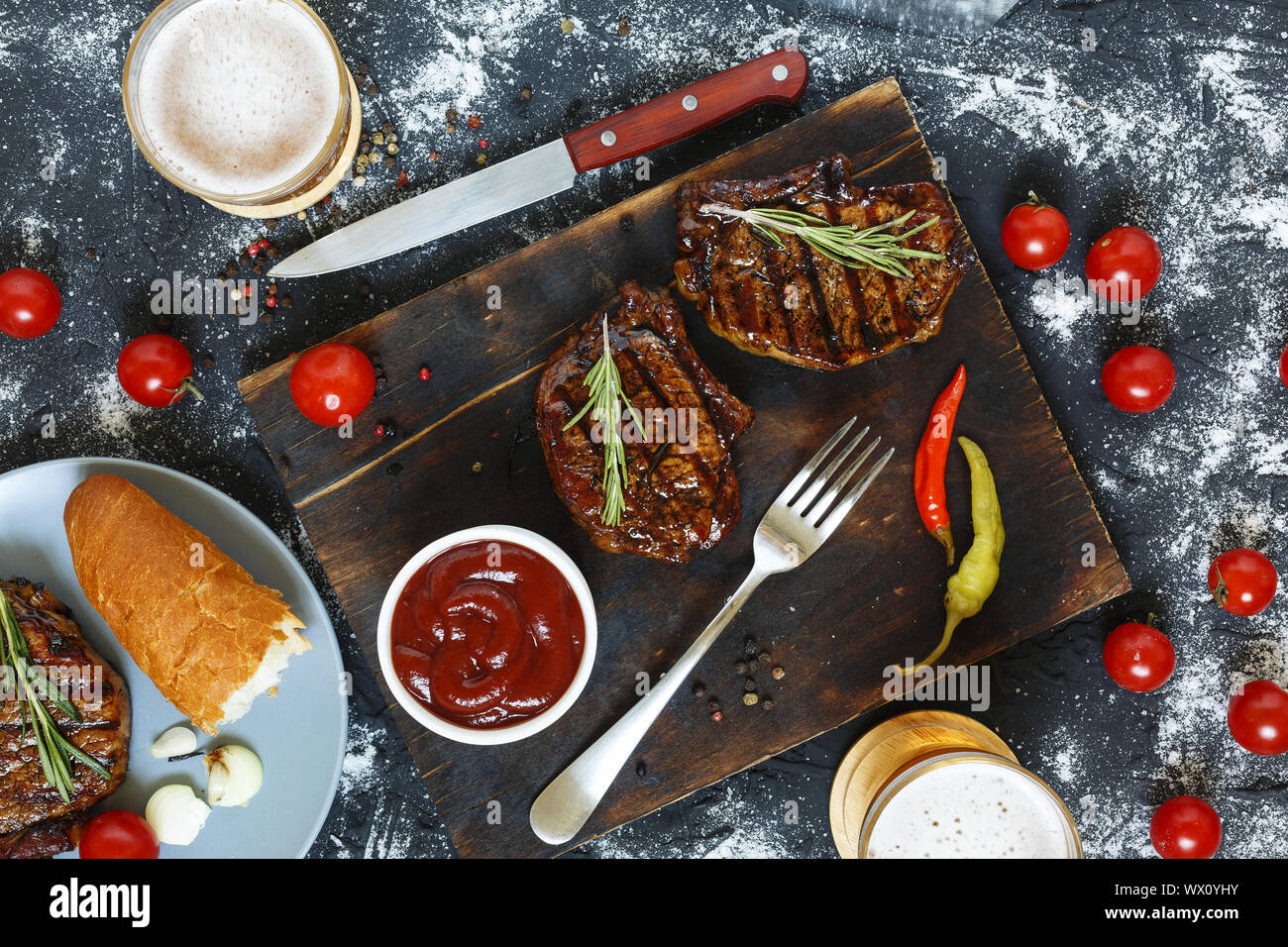 Grilled, Black, Angus, Steak, tomatoes, top view, garlic, chimichurri sauce, meat, cutting board, to Stock Photo