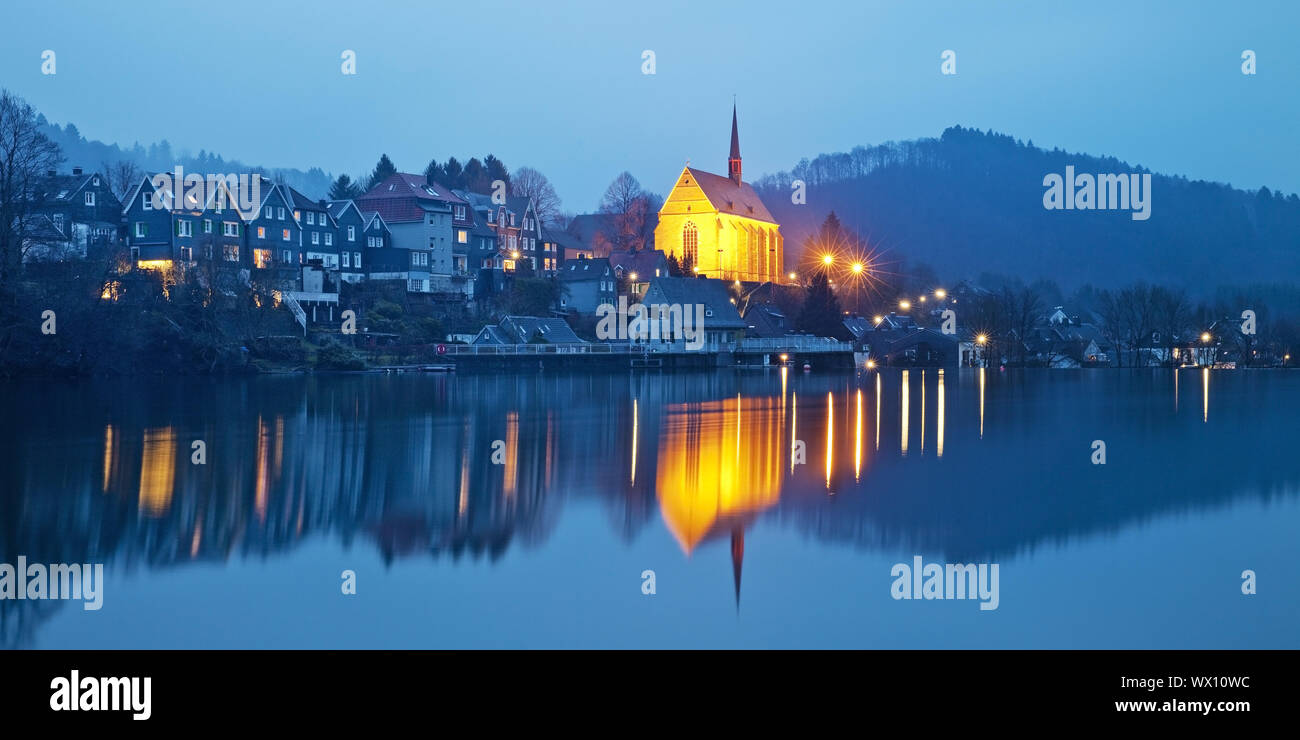 Beyenburg storage lake and illuminated St Mary Magdalena church in the evening, Wuppertal Stock Photo